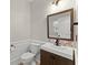 Stylish half bathroom with modern fixtures, including a unique sink and decorative mirror at 336 Parc Xing, Acworth, GA 30102