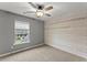 Cozy bedroom featuring shiplap accent wall, window and carpet at 336 Parc Xing, Acworth, GA 30102