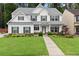 Charming two-story home boasts a well-manicured lawn, welcoming front porch, and classic design details at 336 Parc Xing, Acworth, GA 30102