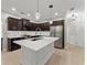 Open concept kitchen with stainless steel appliances, white backsplash, dark cabinets, island, and pendant lighting at 336 Parc Xing, Acworth, GA 30102