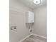 Bright laundry room featuring a white cabinet and hookups for washer and dryer at 336 Parc Xing, Acworth, GA 30102