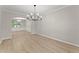 Open-concept living room with archways, fresh paint, updated flooring and modern chandelier at 336 Parc Xing, Acworth, GA 30102