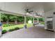 Inviting covered patio with brick pavers, columns, ceiling fans and view of the backyard at 336 Parc Xing, Acworth, GA 30102