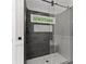 Modern shower with a sleek design, gray tile, rainfall shower head and glass door at 336 Parc Xing, Acworth, GA 30102