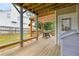Inviting back deck with a pergola, string lights, wooden flooring, and built-in benches perfect for outdoor entertaining at 966 Crest Ridge Sw Dr, Marietta, GA 30060