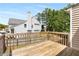 View of wood back deck and backyard with fencing, trees, and view of the side of house at 966 Crest Ridge Sw Dr, Marietta, GA 30060