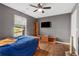 Bedroom with wood floors, a ceiling fan, a TV, and shelving units for storage at 966 Crest Ridge Sw Dr, Marietta, GA 30060