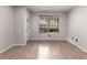 Minimalist room with wood floors, a window with blinds, and a door leading outside at 966 Crest Ridge Sw Dr, Marietta, GA 30060
