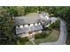 Aerial view of stately home nestled among mature trees, showcasing a welcoming driveway and manicured front yard at 11355 Bowen Rd, Roswell, GA 30075