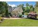 Expansive backyard oasis with outdoor kitchen, pool, and lush landscaping provides the perfect retreat for relaxation and entertainment at 11355 Bowen Rd, Roswell, GA 30075
