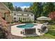 Spacious backyard featuring a well-maintained pool area and ample seating for outdoor relaxation and entertainment at 11355 Bowen Rd, Roswell, GA 30075