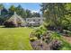 The lush backyard showcases beautiful landscaping and leads to an outdoor living space, enhancing the home's appeal at 11355 Bowen Rd, Roswell, GA 30075