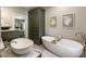 Bathroom with double vanity, soaking tub, and view of the backyard at 11355 Bowen Rd, Roswell, GA 30075