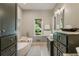 Bathroom with soaking tub, double vanity and storage cabinets at 11355 Bowen Rd, Roswell, GA 30075