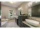 Bathroom with double vanity, soaking tub and view of the yard at 11355 Bowen Rd, Roswell, GA 30075