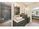 Bathroom with shower, double vanity with marble countertop and view of bedroom at 11355 Bowen Rd, Roswell, GA 30075