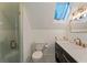 Cozy bathroom featuring a skylight, sleek vanity, and a modern glass shower at 11355 Bowen Rd, Roswell, GA 30075