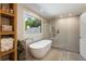 Modern bathroom featuring a soaking tub, separate shower, and natural light at 11355 Bowen Rd, Roswell, GA 30075