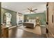 Cozy bedroom featuring natural light, a ceiling fan, and neutral decor at 11355 Bowen Rd, Roswell, GA 30075