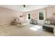 Pink themed bedroom featuring a ceiling fan, natural light, and ample room for play and relaxation at 11355 Bowen Rd, Roswell, GA 30075