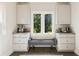 Charming breakfast nook with custom cabinetry, built-in bench, and peaceful backyard views at 11355 Bowen Rd, Roswell, GA 30075