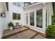 A charming backyard deck with a comfortable bench and a view into the bright and inviting sunroom at 11355 Bowen Rd, Roswell, GA 30075
