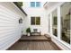 A charming backyard deck with a comfortable bench and a view into the bright and inviting sunroom at 11355 Bowen Rd, Roswell, GA 30075