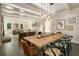 Open dining area connects with living area with elegant lighting fixture and natural light at 11355 Bowen Rd, Roswell, GA 30075
