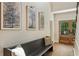Foyer with bench seating, warm lighting, brick floor and decoratively framed prints at 11355 Bowen Rd, Roswell, GA 30075