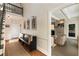 Sunlit foyer with elegant bench and stylish access to living room with fireplace at 11355 Bowen Rd, Roswell, GA 30075