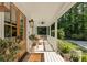 Charming front porch with a ceiling fan, stylish decor, and a view of the surrounding greenery at 11355 Bowen Rd, Roswell, GA 30075