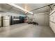 Spacious garage with built-in black cabinets, a refrigerator, and plenty of room for storage and parking at 11355 Bowen Rd, Roswell, GA 30075