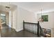 Upstairs hallway with hardwood floors, dark railing and a view of the backyard at 11355 Bowen Rd, Roswell, GA 30075