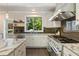 Gourmet kitchen featuring stainless steel appliances, granite countertops, and access to the patio at 11355 Bowen Rd, Roswell, GA 30075