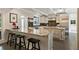 Open kitchen featuring a large island with seating, granite countertops, and stainless steel appliances at 11355 Bowen Rd, Roswell, GA 30075