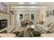 Inviting living room features a charming fireplace, plush seating, and natural light at 11355 Bowen Rd, Roswell, GA 30075