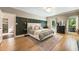 Spacious main bedroom with hardwood floors, fireplace, large windows, and stylish decor at 11355 Bowen Rd, Roswell, GA 30075