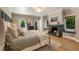 Inviting main bedroom with fireplace, plush bedding, and windows offering natural light at 11355 Bowen Rd, Roswell, GA 30075