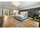 Generous main bedroom featuring a fireplace, wood flooring, and stylish decor at 11355 Bowen Rd, Roswell, GA 30075