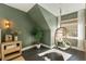 A cozy bedroom corner features a hanging chair, accent lighting, and natural light from a window at 11355 Bowen Rd, Roswell, GA 30075