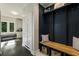 Stylish mud room with built-in storage, bench, and hooks for organization, leading to breakfast nook at 11355 Bowen Rd, Roswell, GA 30075