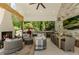 Covered outdoor living space with comfortable seating, a fireplace, outdoor kitchen, and dining area at 11355 Bowen Rd, Roswell, GA 30075