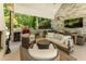 Inviting outdoor covered patio with fireplace, outdoor kitchen, and dining area with comfortable seating at 11355 Bowen Rd, Roswell, GA 30075
