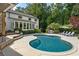 Beautiful backyard with an in-ground pool, outdoor kitchen, lounge chairs, and lush landscaping at 11355 Bowen Rd, Roswell, GA 30075