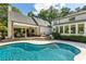 A lovely swimming pool with an attached covered patio and outdoor dining area with convenient seating at 11355 Bowen Rd, Roswell, GA 30075