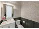 Chic powder room featuring patterned wallpaper, a marble vanity, and modern fixtures at 11355 Bowen Rd, Roswell, GA 30075