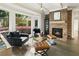 Comfortable sitting room with large windows, fireplace, hardwood floors, and natural light at 11355 Bowen Rd, Roswell, GA 30075