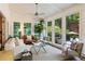 Bright sunroom with floor-to-ceiling windows, comfortable seating, and ample natural light at 11355 Bowen Rd, Roswell, GA 30075
