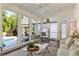 Inviting sunroom with brick floors, wicker chair, large windows with a view to the pool, and bright natural light at 11355 Bowen Rd, Roswell, GA 30075