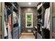 Walk-in closet has custom shelves and drawers as well as floral wallpaper at 11355 Bowen Rd, Roswell, GA 30075